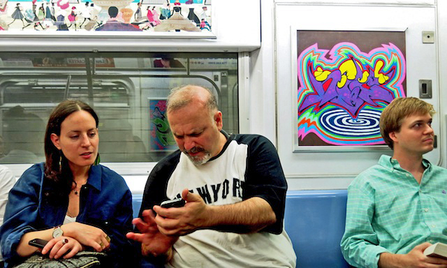 Nic sharing moments of graffiti history with interested subway rider